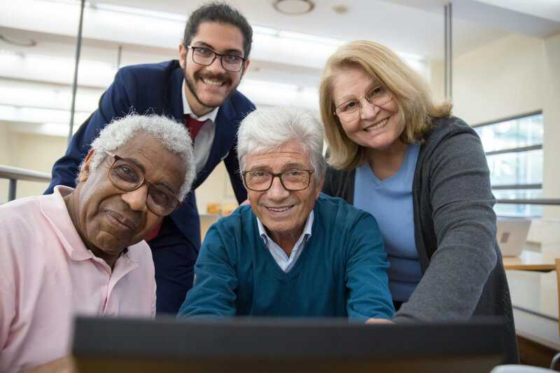Group of adults smiling confidently, showcasing results of dental bridge care